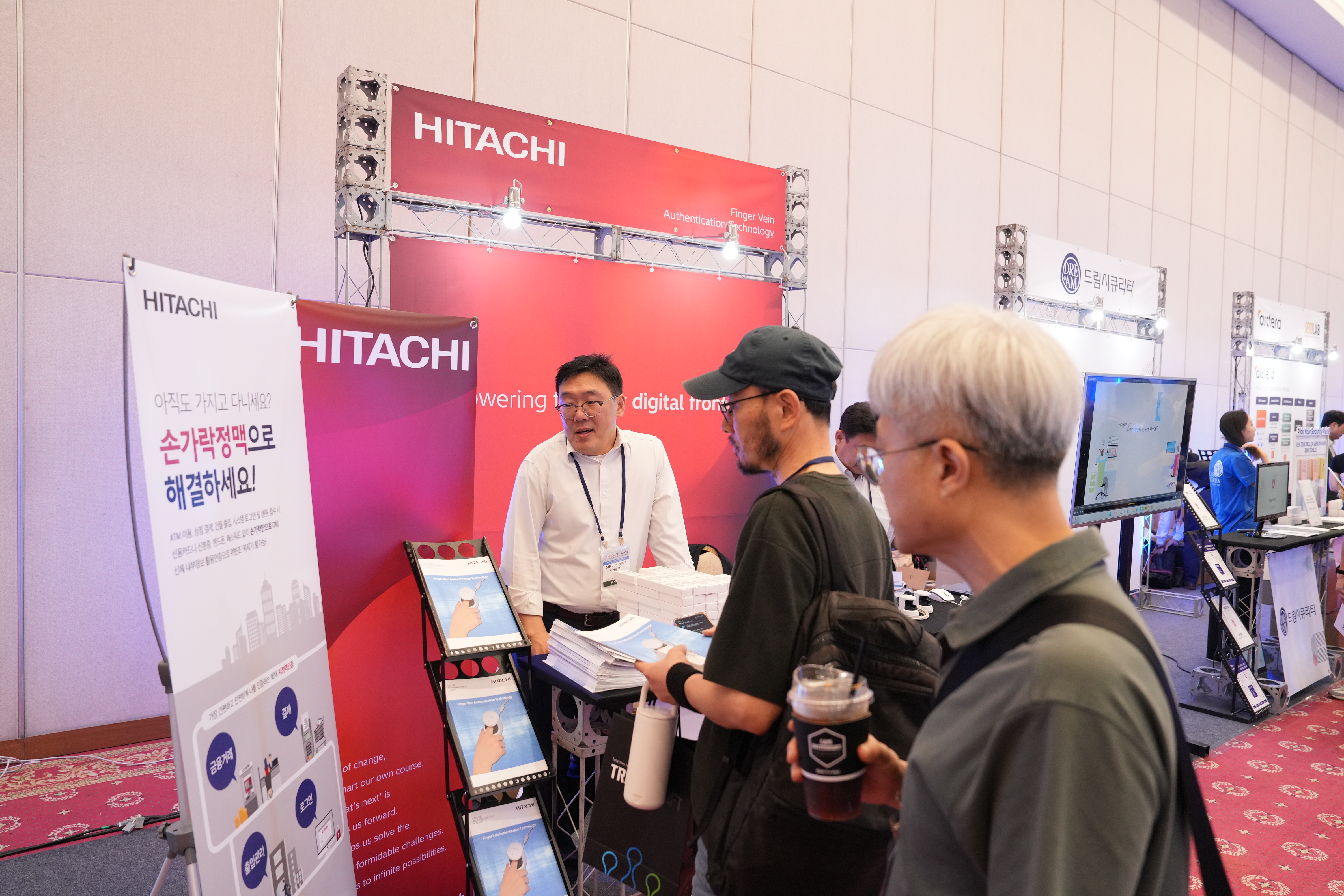 사진: 히타치 부스에서 방문객들에게 지정맥 인증 솔루션을 소개하는 모습